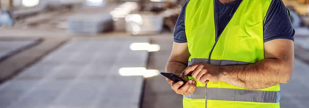 Subcontractor on the jobsite checking payment status by phone before sending a notice of intent