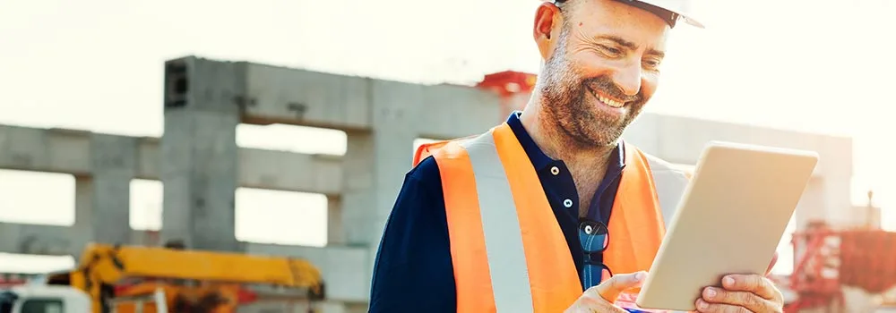 A contractor reviewing a finished job on a tablet, a natural moment to ask for referrals