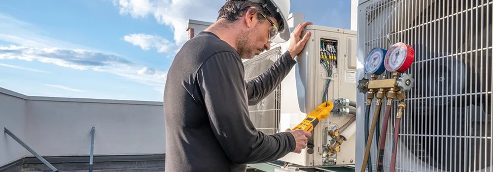 HVAC tech testing a rooftop unit, the kind of field work your software has to keep up with