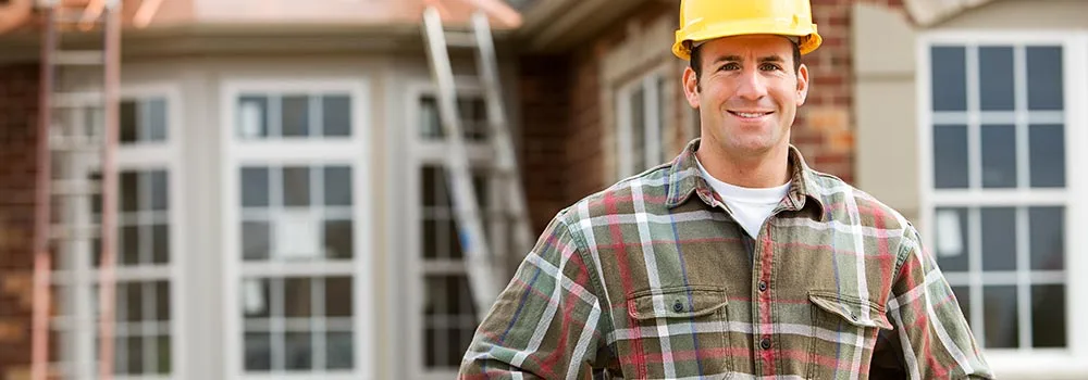 A contractor looks at a kitchen that is half drawing and half finished work, the picture a detailed proposal paints for the customer