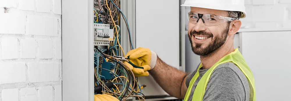 A digital clamp meter reads an electrical panel; field tools went digital first, and office software is the natural next step